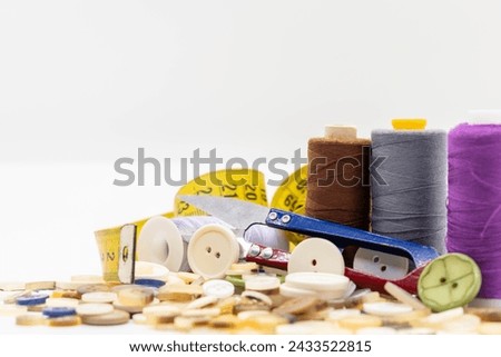 Sewing accessories, mending clothing, colorful threads, tape measure, buttons and scissors.