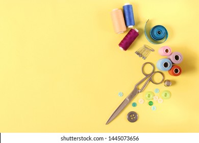 sewing accessories on a colored background top view.
 - Powered by Shutterstock