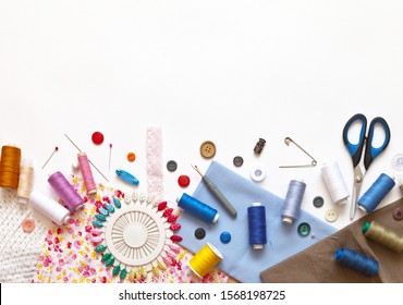 Sewing accessories: threads, fabrics, scissors, buttons, needles, pins and other sewing tools on a white background. Top view, copy space, flat lay, mock up
 - Powered by Shutterstock