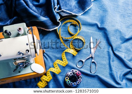 sewing indigo denim jeans with sewing machine, garment industrial concept