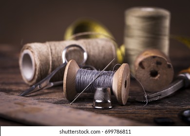 Sewing instruments, threads, needles, bobbins and materials. Studio photo