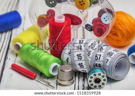 sewing kit from a thimble of colored thread buttons of needles and a centimeter