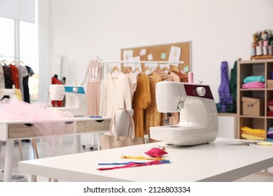 Sewing machine and accessories on table in dressmaking workshop