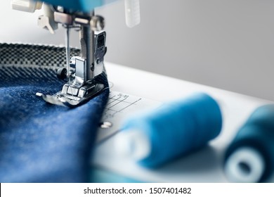 Sewing machine with denim and thread for sewing, close-up. The working process. Part of a sewing machine with blue cloth. - Shutterstock ID 1507401482