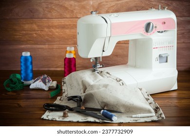 Sewing machine with fabric and threads for sewing, close-up. The working process. Part of a sewing machine with fabric.