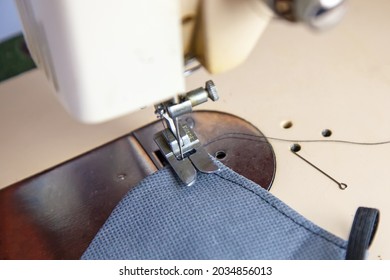 Sewing machine foot close-up. Create clothing and household items with your own hands. Factory for the production of knitwear and things. . Home hobbies of fashion designers. - Shutterstock ID 2034856013