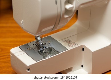 Sewing Machine At Home, With Foot Partially Up.  Equipment Being Prepared For Diy Project, Indoors Closeup.