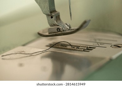Sewing machine needle and thread close up, shallow depth of field