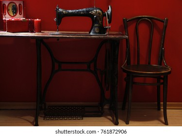 Sewing machine on red background. Vintage style.