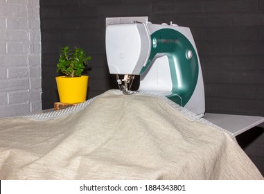 Sewing machine on the table close-up. Freelance. sewing linen curtains…