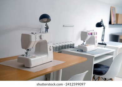 Sewing machine on the table in the sewing workshop. Sewing accessories. - Powered by Shutterstock