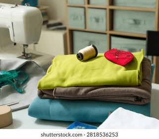 Sewing machine set up on white craft table ready for creative project. Stitch machine prepared with sewing equipment for productive craft work. Crafting tool arranged for DIY textile stitching at home