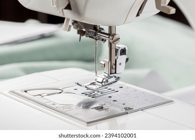 Sewing machine, stitching fabrics, needle in a round plan close up
