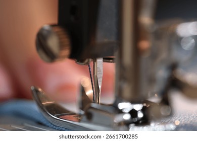 Sewing machine with thread and cloth, macro view