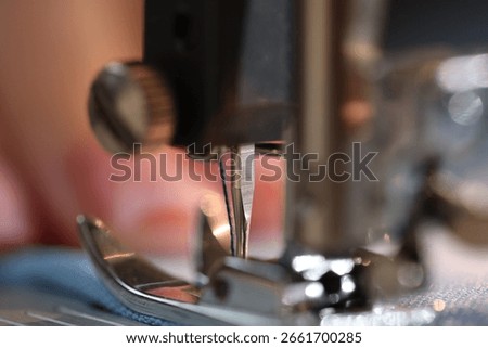 Sewing machine with thread and cloth, macro view