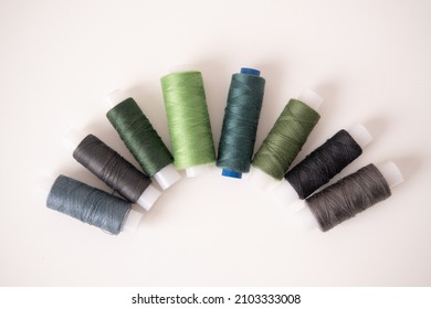 Sewing machine threads in green colors. Flat lay, top view. High quality photo