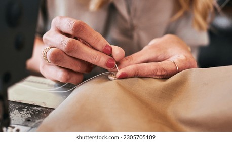 Sewing machine, woman hands and clothing designer with button and thread work. Small business, entrepreneur and female tailor with boutique and creative worker working with machinery for fashion - Powered by Shutterstock