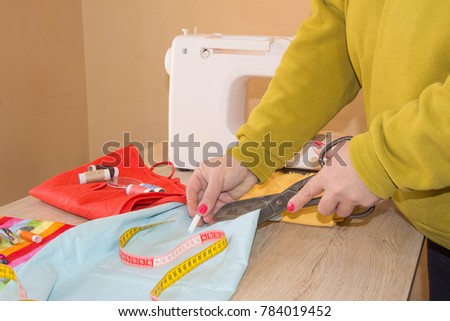 Sewing machine.sewing process in the phase of overstitching. Dressmaker work on the sewing machine.Tailor making a garment in workplace. Hobby sewing fabric as a small business concept