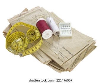 Sewing materials - pattern, thread, needles, tape measure. Isolated. Dressmaking, haberdashery.