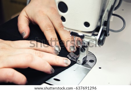 Sewing Process - Women's hands behind her sewing