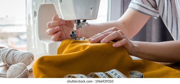 Sewing. Recycling Made by hand from home. sewing machine  project quarantine, lockdown. home sewing,Hobby, meditation,zero waste,recycling. Girl sews clothes home  sewing machine, ecology zero waste - Shutterstock ID 1966929310