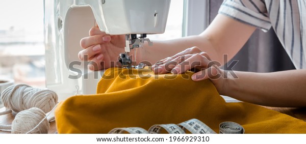 Sewing. Recycling Made by hand from home.\
sewing machine  project quarantine, lockdown. home sewing,Hobby,\
meditation,zero waste,recycling. Girl sews clothes home  sewing\
machine, ecology zero\
waste