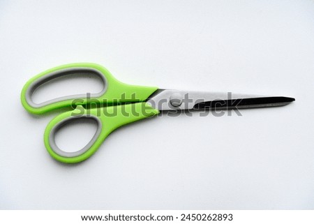 Sewing scissors on a white background. Green scissors.