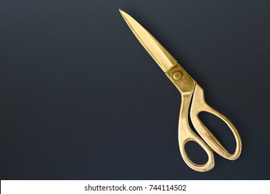 Sewing Scissors Or Tailoring Scissors Titanium Professional For Heavy Duty Isolated On Black Board Background. Dressmaking Scissors Isolated On Black Board