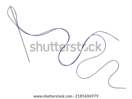 Sewing thread and needle isolated at white background, top view