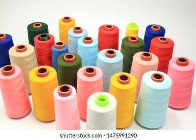 The sewing threads of colorful on top view in white background.