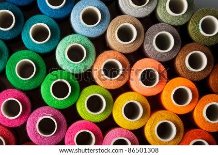 Sewing threads multicolored background closeup