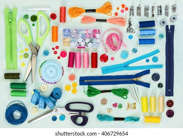 Sewing tool and accessories on painted background blue color, top view. Flat lay.