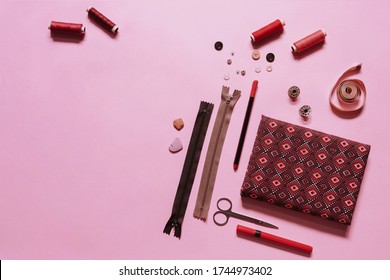 Sewing tool kit flat lay photo in monochrome reddish pink theme. Conceptual photo banner with copy space
