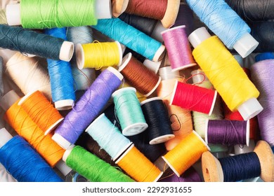 Sewing tool for needlework, colored threads centimeter and buttons with a pair of scissors on the table close-up.