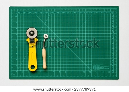 Sewing tools on a fabric cutting board, rotary cutter, tracing wheel, rotary wheel, rotary cutters tailoring  DIY