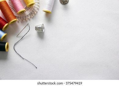 Sewing tools on white fabric background diagonal set.  Horizontal composition. Top view