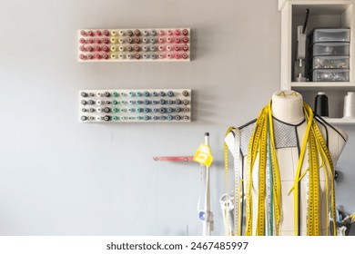 Sewing workshop. Mannequin for trying on clothes. Multi-colored threads for sewing. Copy space. - Powered by Shutterstock