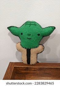 Sewn Yoda sitting on a shelf