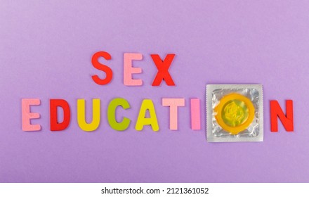 Sex Education Concept. Bright Condoms On Purple Background.Safe Sex Concept.HIV, AIDS Cancer Awareness.sexy Healthcare Concept, World AIDS Day. Flat Lay