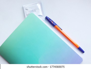 Sex Education. How To Talk To Kids About Sex. Notebook, Pen And Condom. Empty Copyspace. STD Prevention.