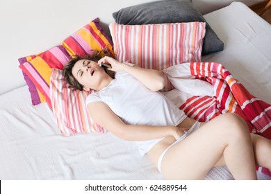 Sex on the phone. Young woman masturbating. Above view