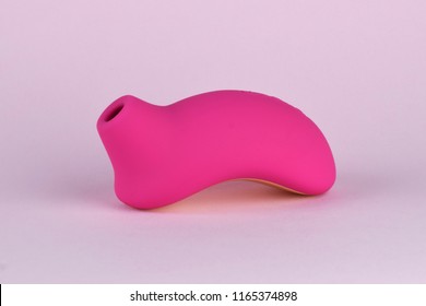 Sex toy for adult, design minimal dildo vibrator for clitoris isolated on pink background. Minimal concept.
