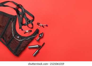 Sex toys and underwear on color background