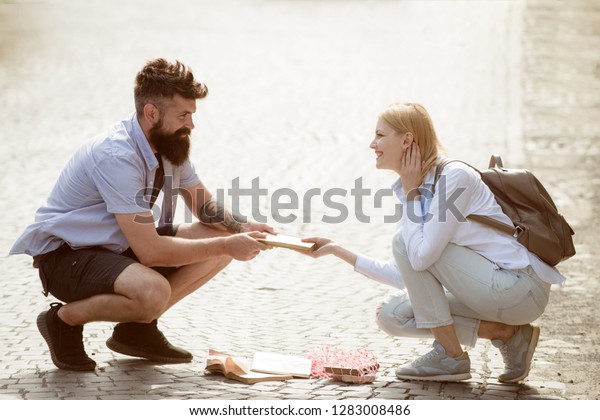 Sexual\
attraction. Couple in love on summer street. Hipster helping and\
looking at sexy girl. Bearded man and sexy woman falling in love.\
Love at first sight. Romantic date and\
dating.