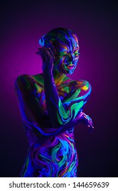 Sexual dancer posing with UV pattern on body