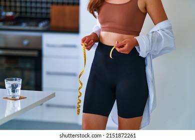 Sexual Fitness Woman With Beautiful Thin Fit Body Figure And Slim Waist Measures Waist With Centimeter Tape. Diet And Wellness Healthy Lifestyle