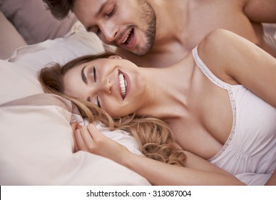 Sexual scene of passionate young couple in the bedroom