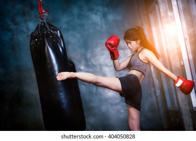 sexy asia girl punching boxing bag