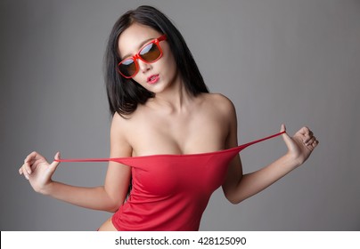 Sexy asian girl wearing red shirt and red underwear, wearing sunglasses.