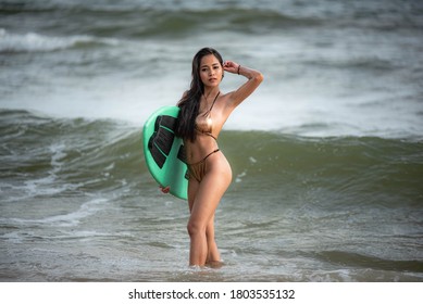 Sexy Asian Surfer Woman In Bikini Swimwear With Surfboard On The Beach/Extreme Sport On Summer Holiday Vacation